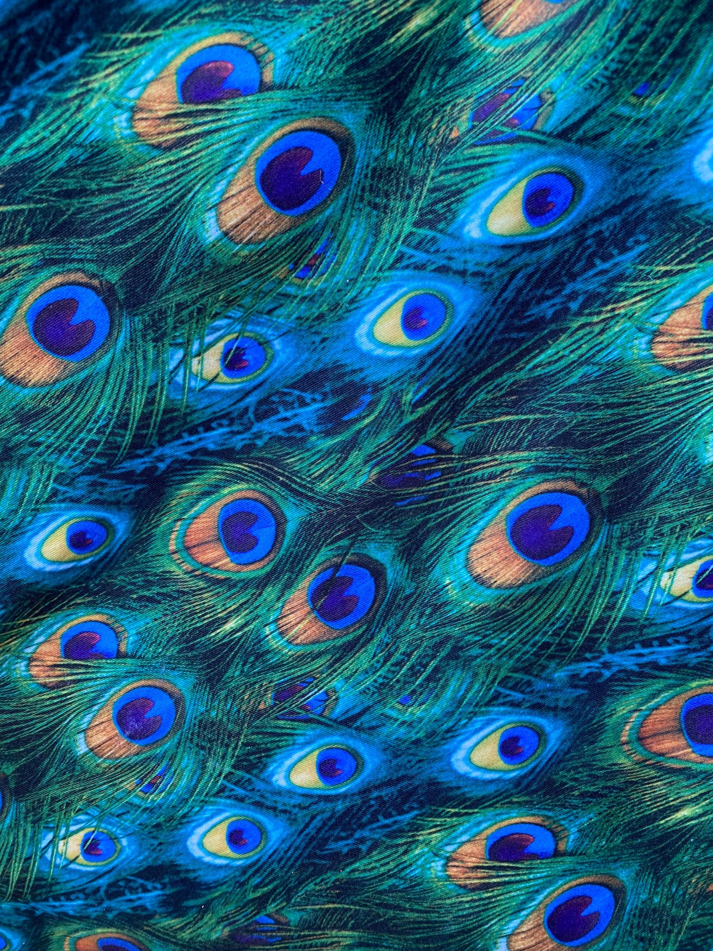 Peacock design print of great quality of nylon spandex 4-way stretch 58/60” Sold by the YD. Ships worldwide from Los Angeles California USA.