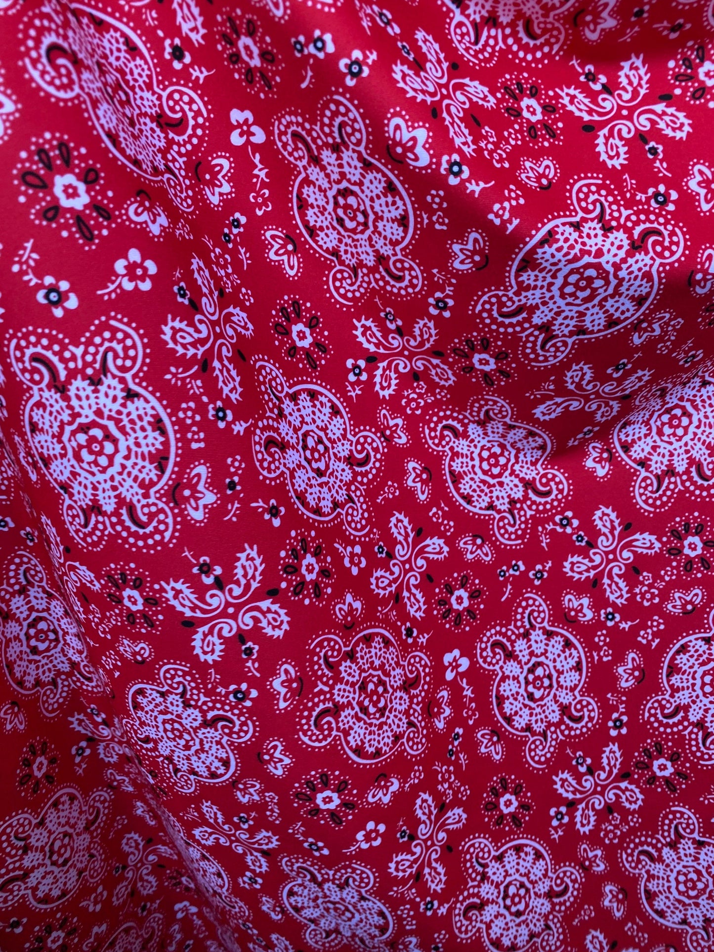 Red bandana design print on great quality of brushed poly spandex 4-way stretch medium weight 58/60” Sold by the YD.