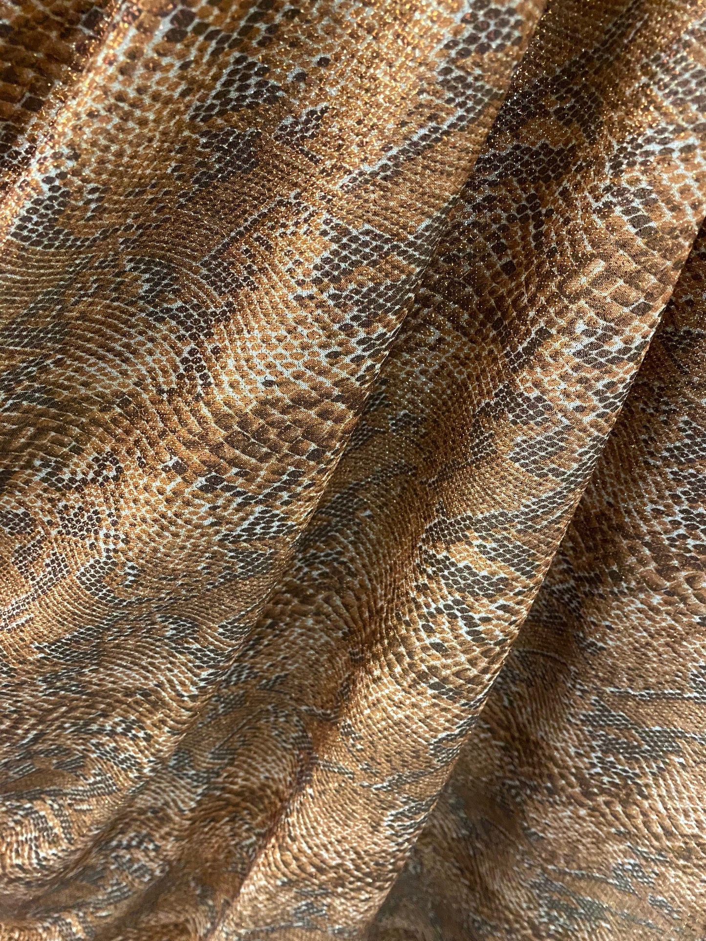 New exotic snake design metallic hologram poly spandex bronce color médium weight 2-way Stretch 58/60" Sold by the YD. Ships worldwide