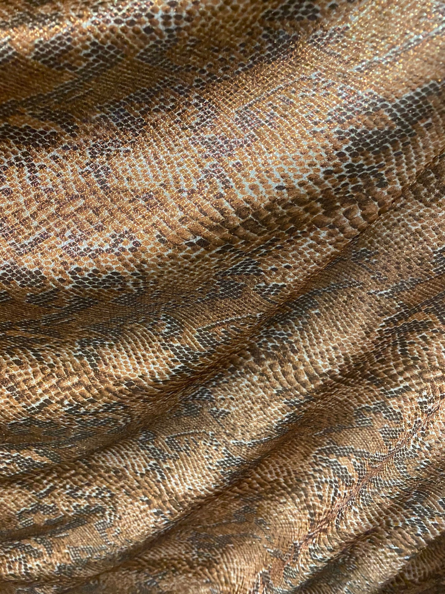 New exotic snake design metallic hologram poly spandex bronce color médium weight 2-way Stretch 58/60" Sold by the YD. Ships worldwide