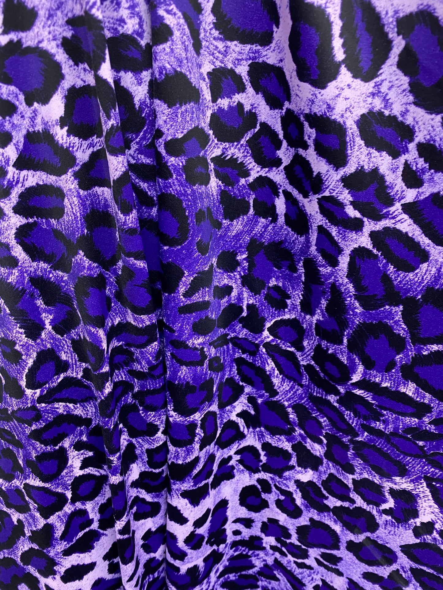 Exotic leopard design purple/black print on nylon spandex 4-way stretch 58/60” Sold by the YD. Ships worldwide from Los Angeles California