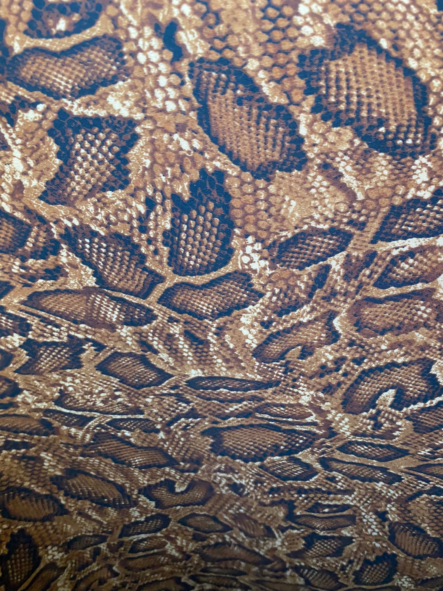 New exotic snake design copper print on poly techno 2-way stretch medium weight 58/60” Sold by the YD. Ships worldwide