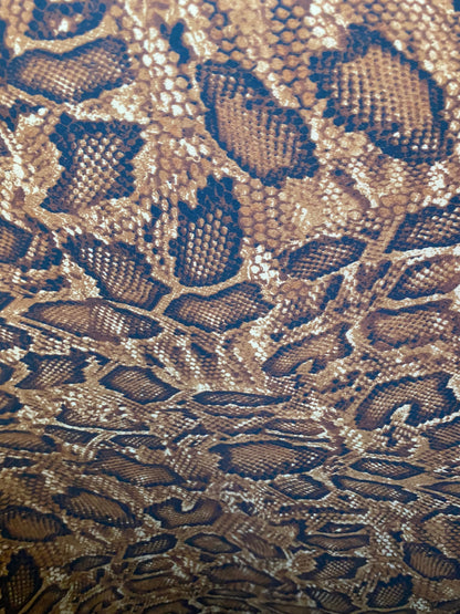 New exotic snake design copper print on poly techno 2-way stretch medium weight 58/60” Sold by the YD. Ships worldwide