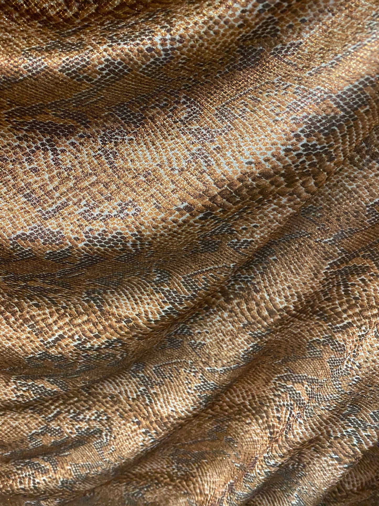 New exotic snake design metallic hologram poly spandex bronce color médium weight 2-way Stretch 58/60" Sold by the YD. Ships worldwide