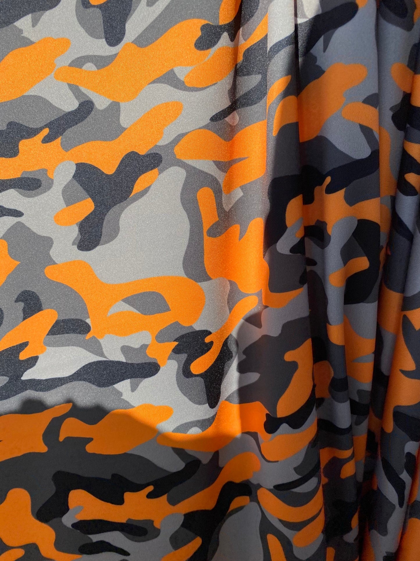 New modern camouflage Orange/black/Gray print on great quality of nylon spandex 4-way stretch 58/60” Sold by the YD.