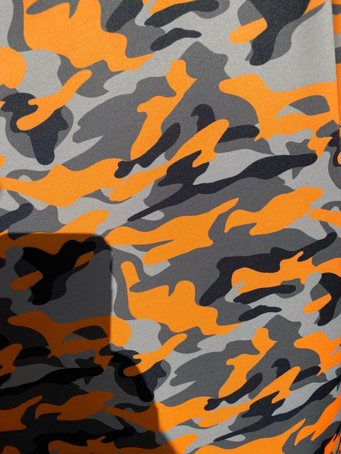 New modern camouflage Orange/black/Gray print on great quality of nylon spandex 4-way stretch 58/60” Sold by the YD.