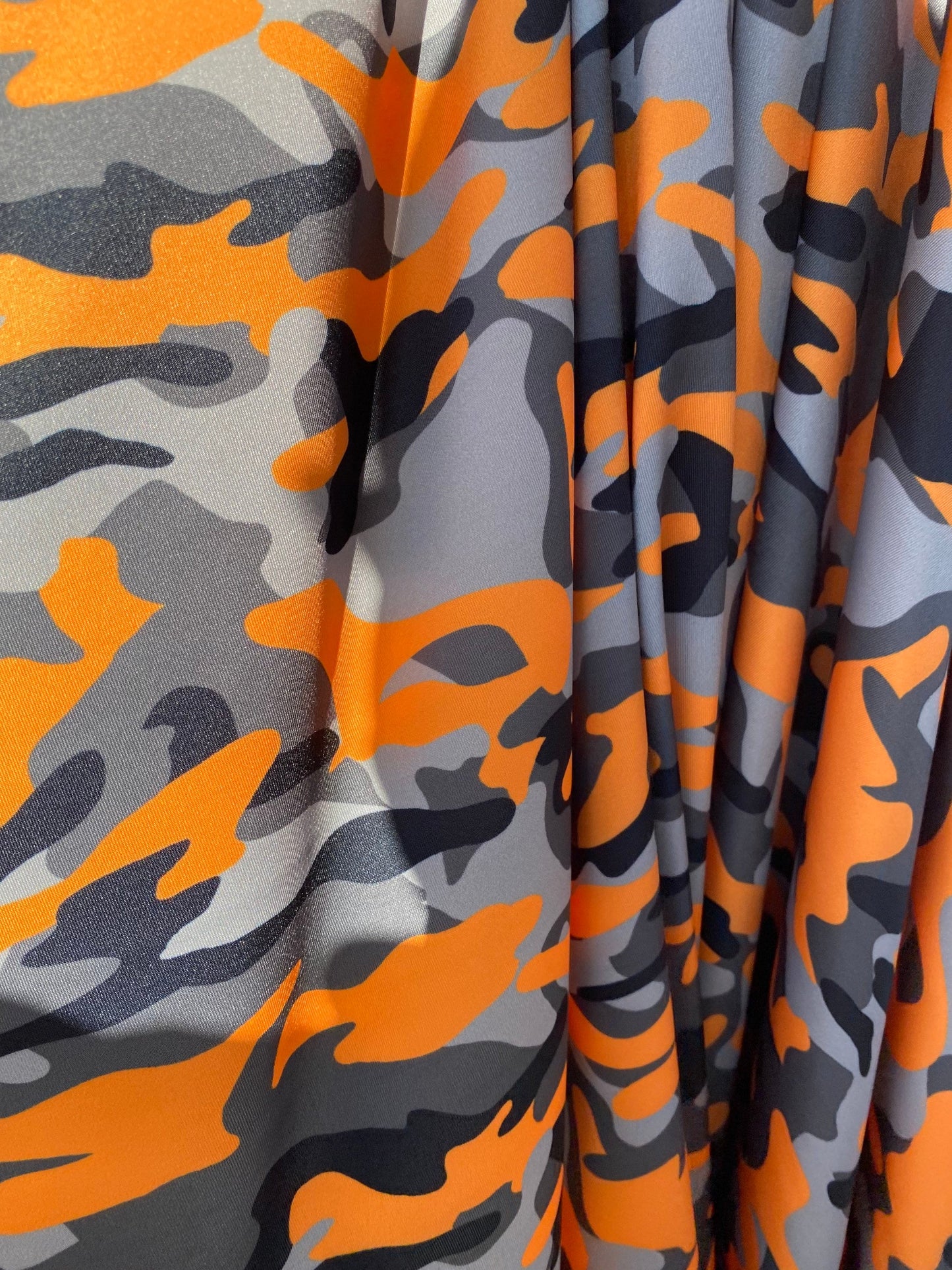 New modern camouflage Orange/black/Gray print on great quality of nylon spandex 4-way stretch 58/60” Sold by the YD.