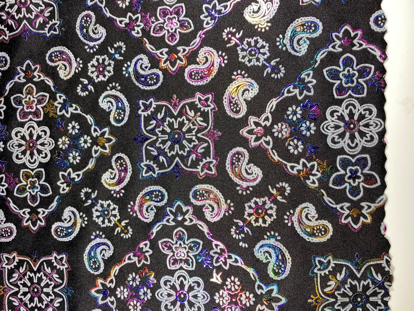 New Bandanna paisley design black/rainbow metallic nylon spandex 4-way stretch 58/60” Sold by the YD. Ships Worldwide from Los Angeles cali