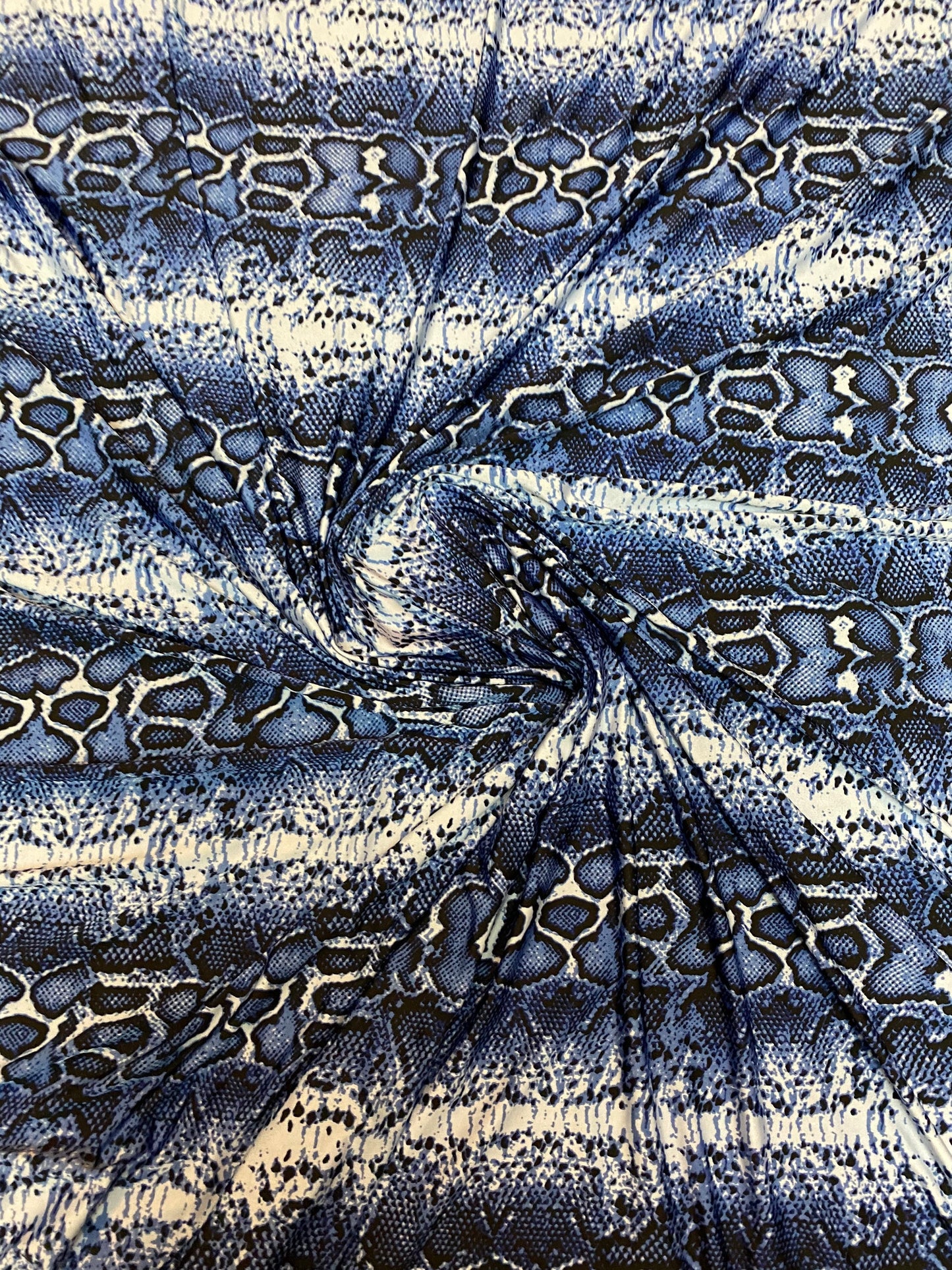 New snake skin sapphire/blue color print on poly spandex light weight 4-way stretch 58/60” Sold by the YD. Ships Worldwide from Los Angeles