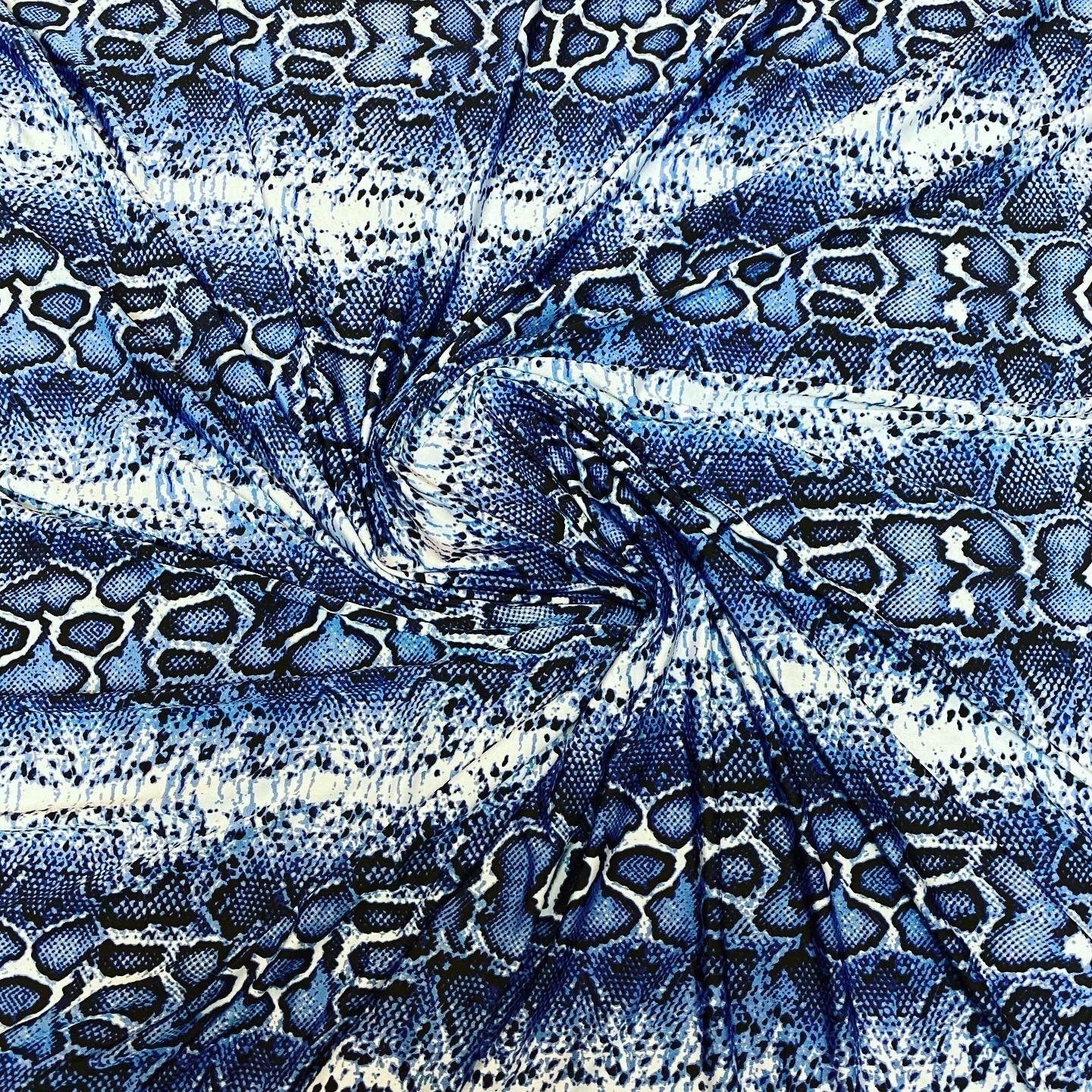 New snake skin sapphire/blue color print on poly spandex light weight 4-way stretch 58/60” Sold by the YD. Ships Worldwide from Los Angeles