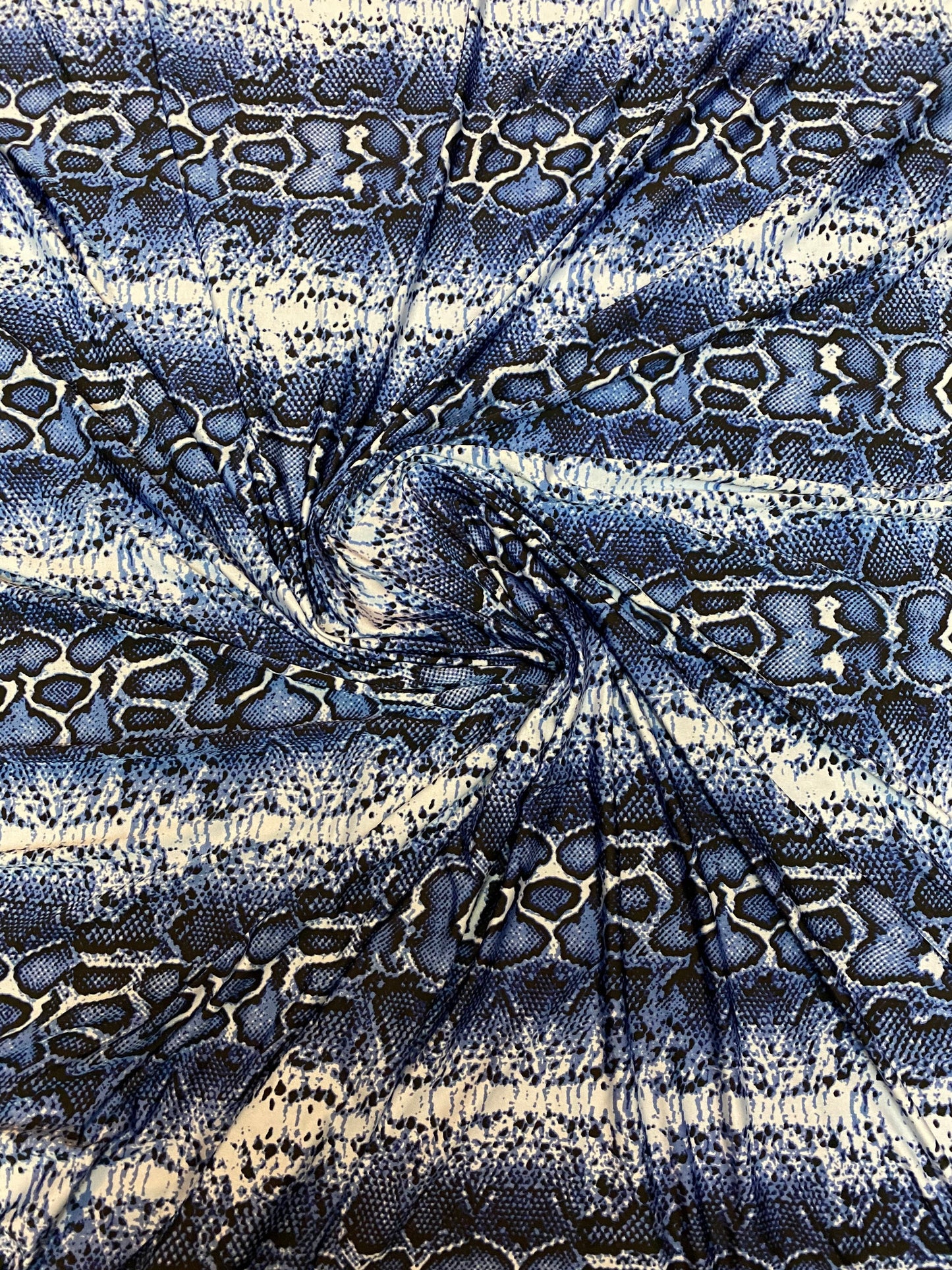 New snake skin sapphire/blue color print on poly spandex light weight 4-way stretch 58/60” Sold by the YD. Ships Worldwide from Los Angeles