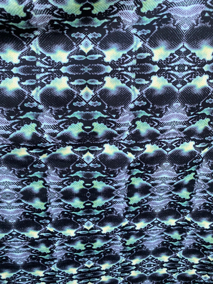 Serpent design Black/Green print on nylon spandex 4-way stretch 58/60” Sold  by the YD. Ships worldwide from Los Angeles California USA.