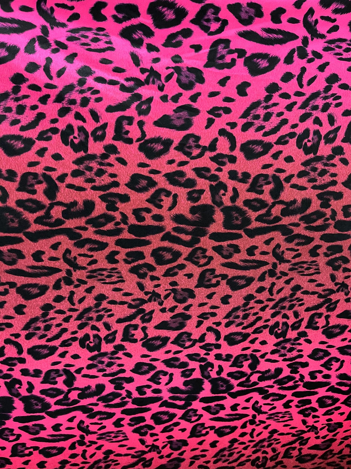 Exotic leopard design print on nylon spandex ;-way stretch Hop pink/black 58/60” Sold by the YD. Ships Worldwide from Los Angeles California