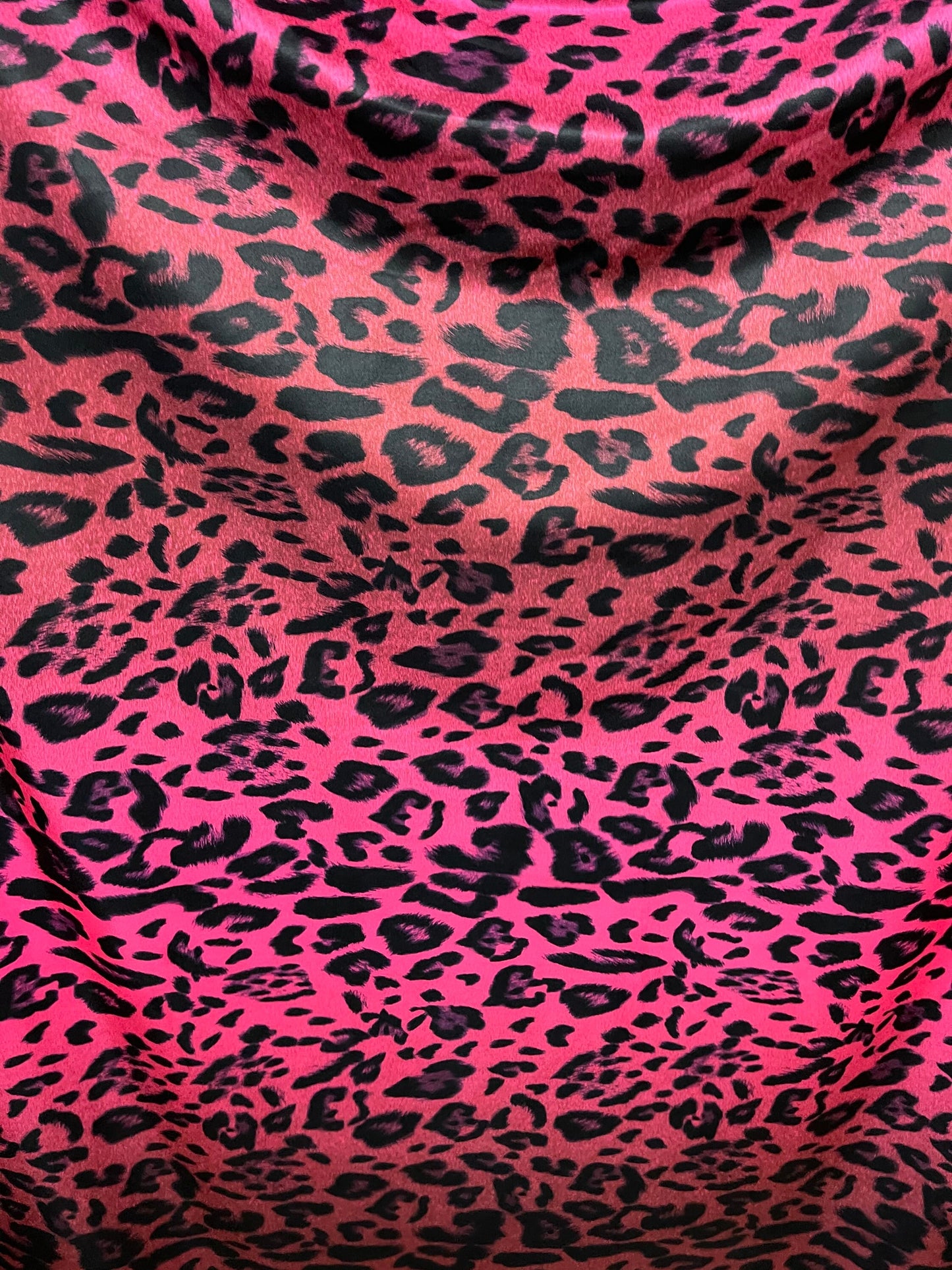 Exotic leopard design print on nylon spandex ;-way stretch Hop pink/black 58/60” Sold by the YD. Ships Worldwide from Los Angeles California