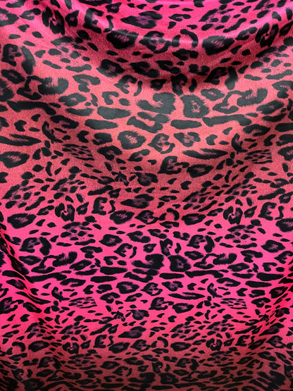 Exotic leopard design print on nylon spandex ;-way stretch Hop pink/black 58/60” Sold by the YD. Ships Worldwide from Los Angeles California