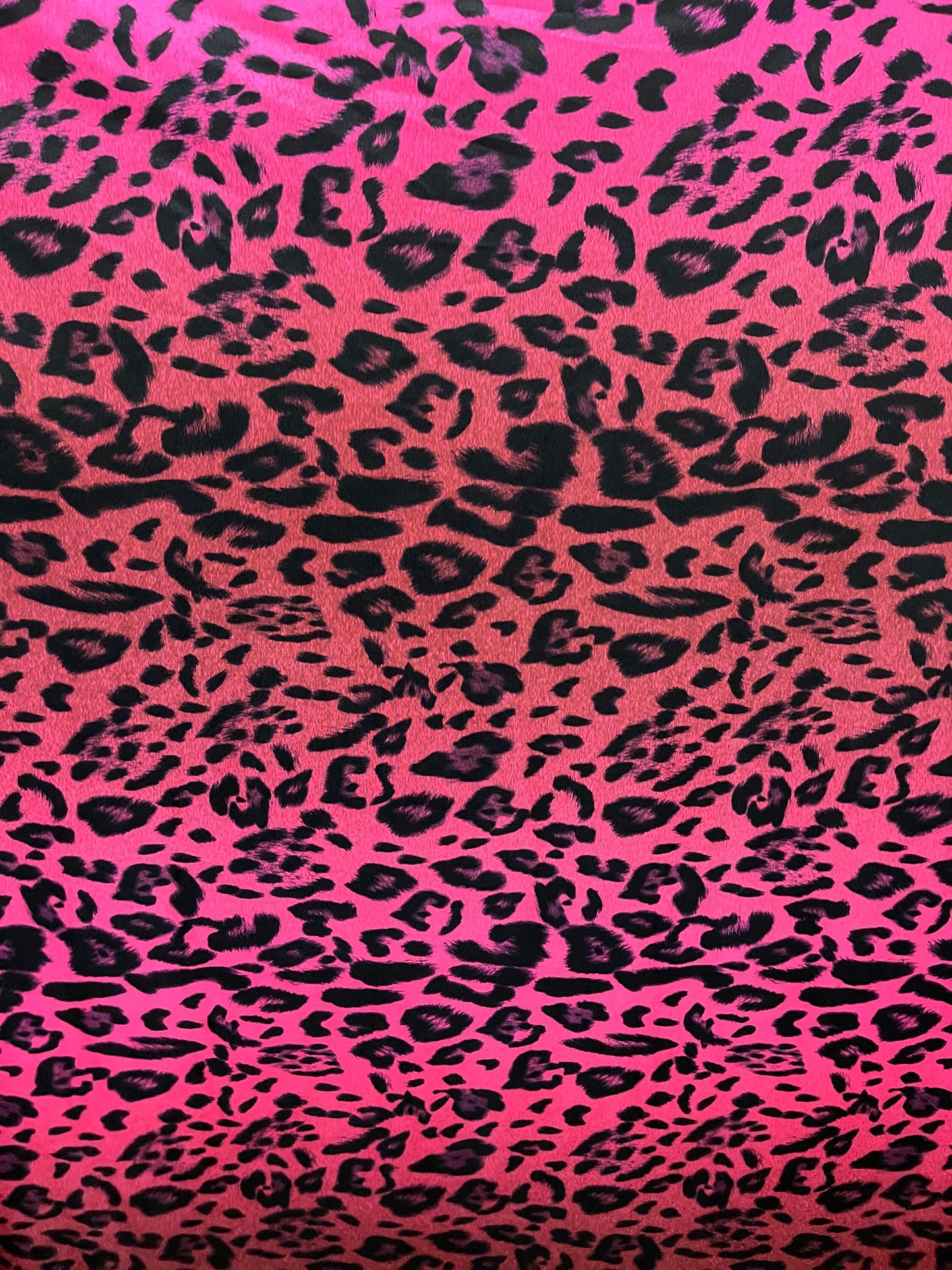 Exotic leopard design print on nylon spandex ;-way stretch Hop pink/black 58/60” Sold by the YD. Ships Worldwide from Los Angeles California