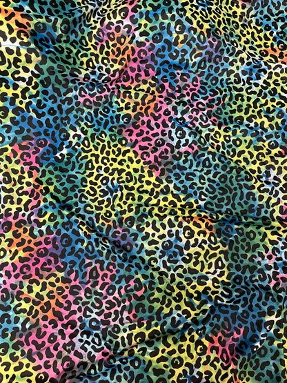 Exotic leopard design print on tie dye nylon spandex 4-way stretch 58/60” Sold by the YD. Ships Worldwide from Los Angeles California USA.