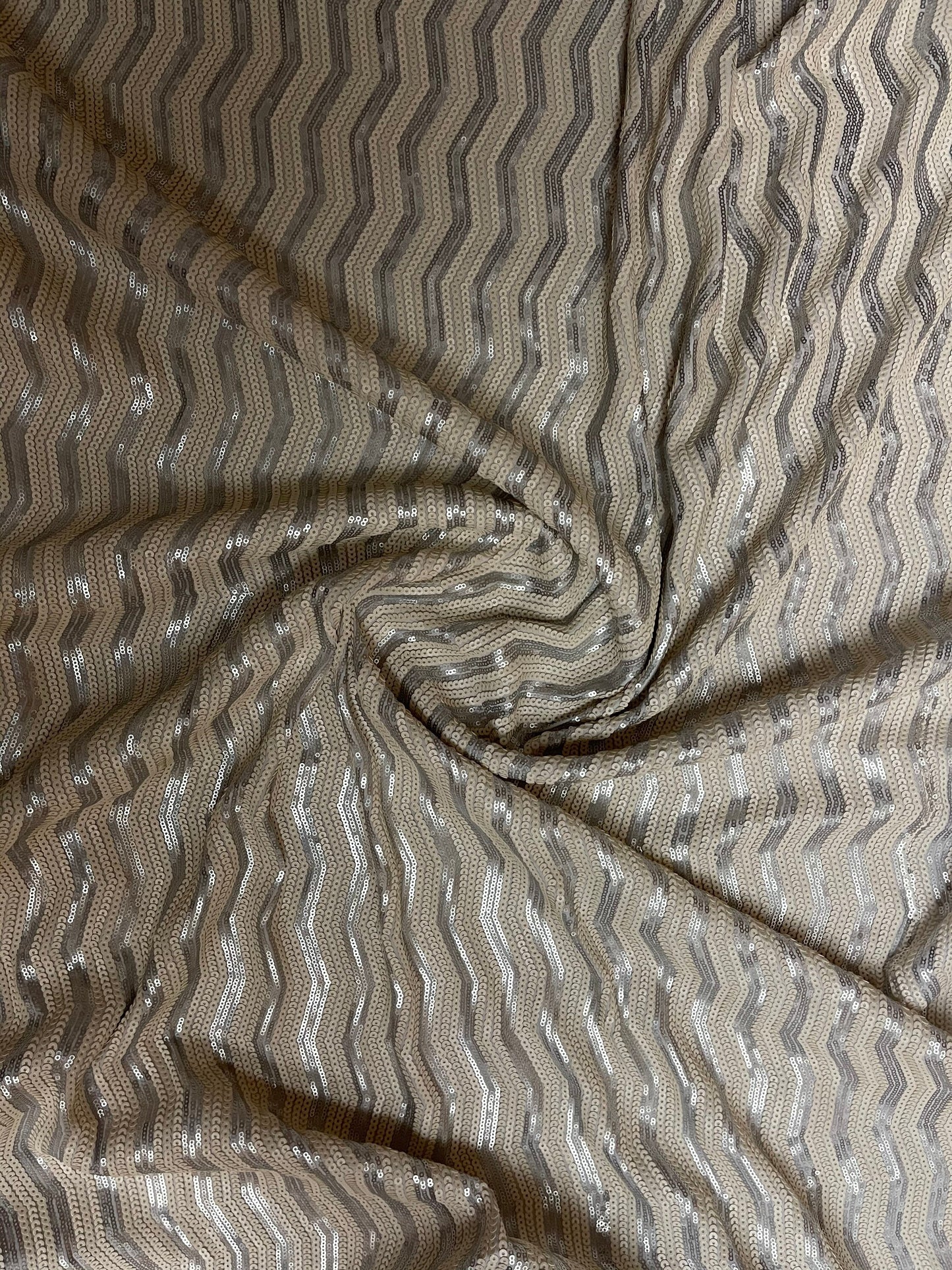 Luxury Chevron design embroidered on spandex base 2-way stretch silver/pearl white sequins 58/60” Sold by the YD. Ships Worldwide from L.A