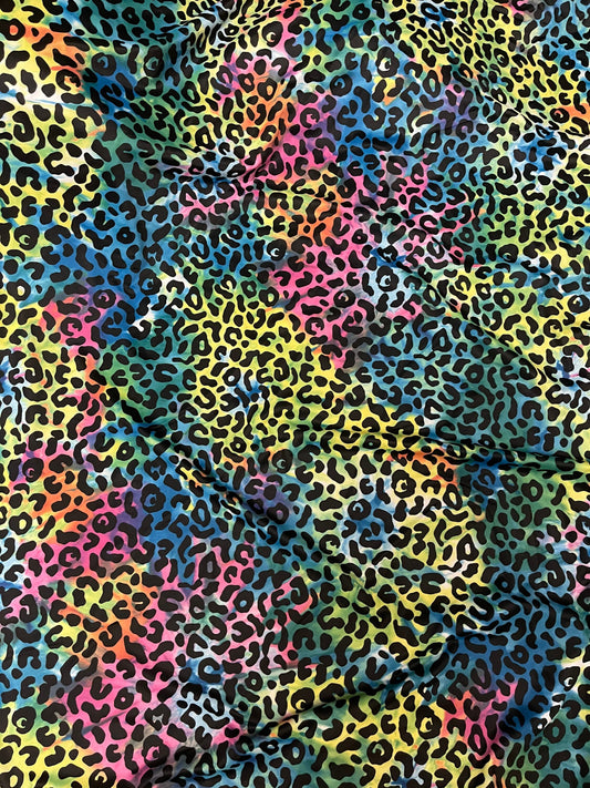 Exotic leopard design print on tie dye nylon spandex 4-way stretch 58/60” Sold by the YD. Ships Worldwide from Los Angeles California USA.