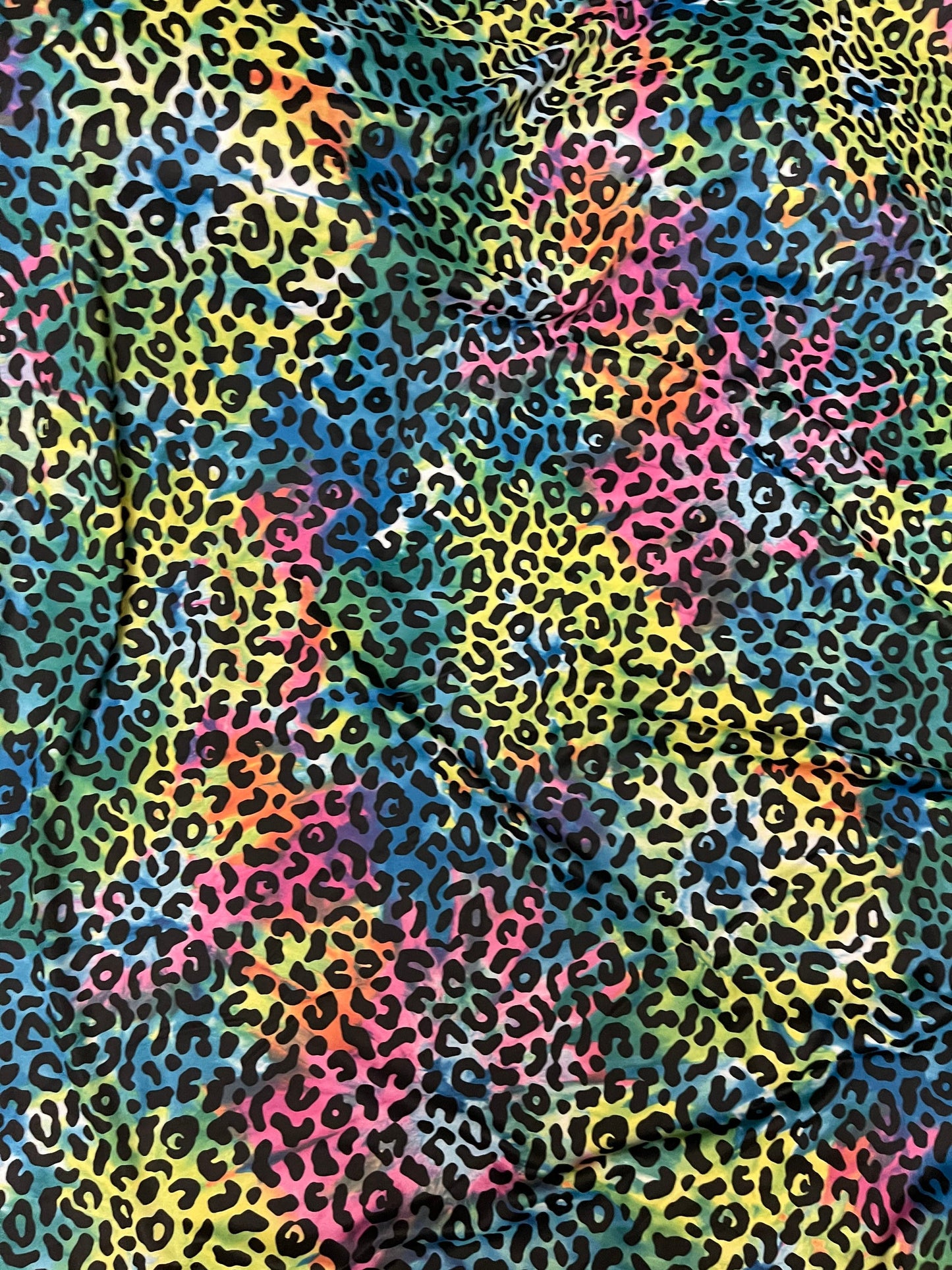 Exotic leopard design print on tie dye nylon spandex 4-way stretch 58/60” Sold by the YD. Ships Worldwide from Los Angeles California USA.