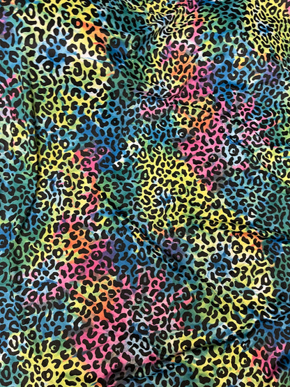 Exotic leopard design print on tie dye nylon spandex 4-way stretch 58/60” Sold by the YD. Ships Worldwide from Los Angeles California USA.