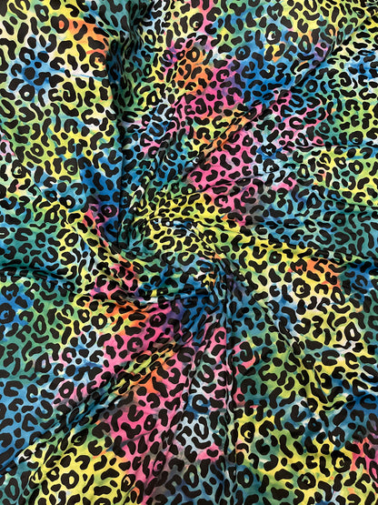 Exotic leopard design print on tie dye nylon spandex 4-way stretch 58/60” Sold by the YD. Ships Worldwide from Los Angeles California USA.