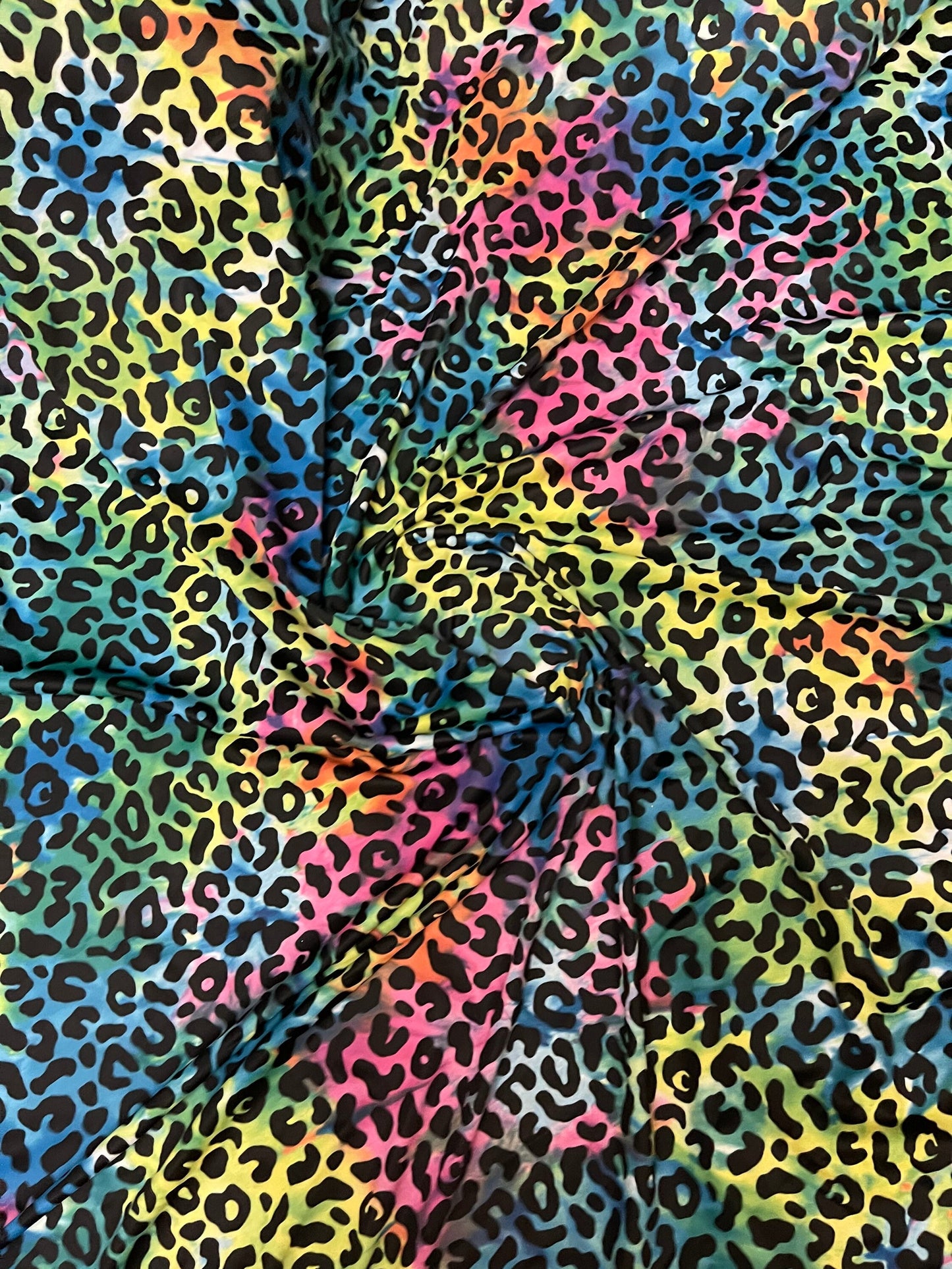 Exotic leopard design print on tie dye nylon spandex 4-way stretch 58/60” Sold by the YD. Ships Worldwide from Los Angeles California USA.