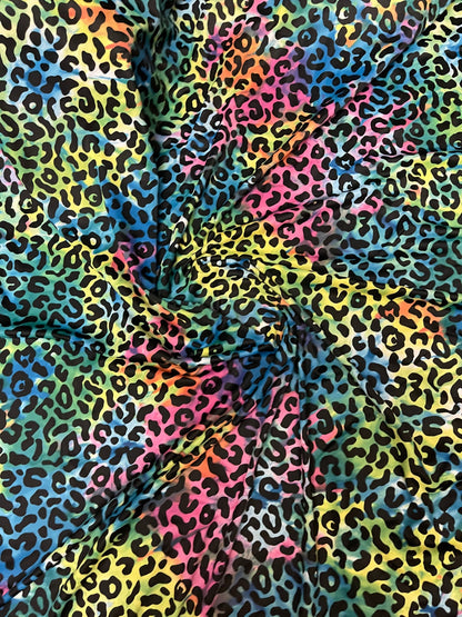 Exotic leopard design print on tie dye nylon spandex 4-way stretch 58/60” Sold by the YD. Ships Worldwide from Los Angeles California USA.