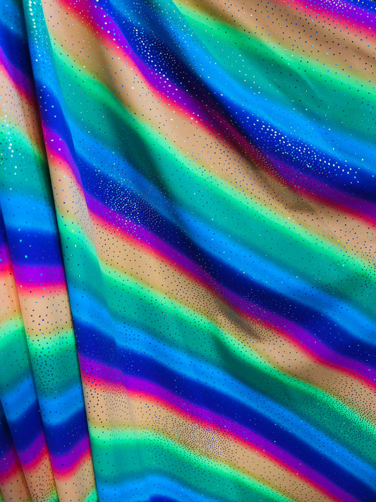 New Rainbow design with sparkling foil it glows in the dark best quality of nylon spandex 4-way stretch 58/60” Sold by the YD.