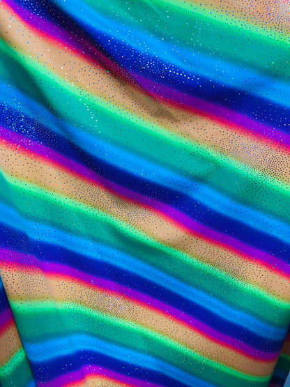 New Rainbow design with sparkling foil it glows in the dark best quality of nylon spandex 4-way stretch 58/60” Sold by the YD.