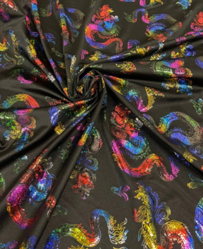 New Dragon design print on metallic nylon spandex Black Iridescent rainbow 4-way stretch spandex 58/60” Sold by the YD. Ships worldwide