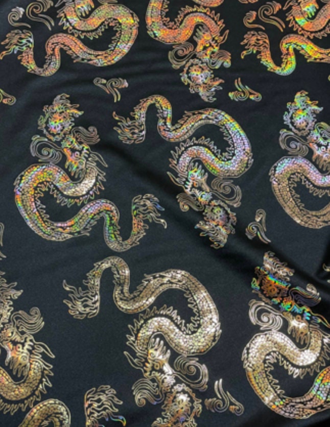 New Dragon design print on metallic nylon spandex Black Iridescent gold 4-way stretch spandex 58/60” Sold by the YD. Ships worldwide