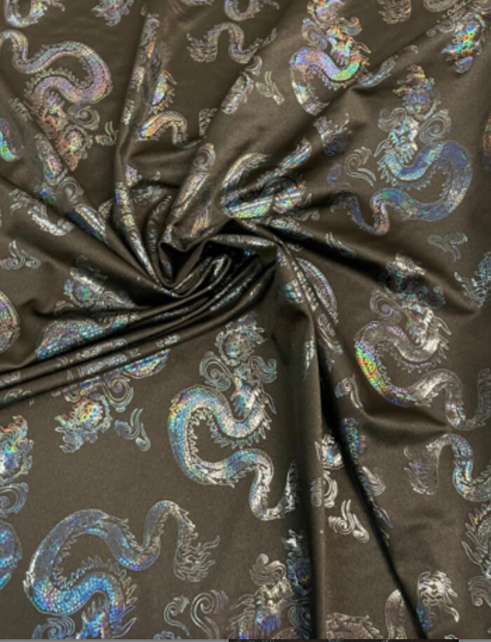 New Dragon design print on metallic nylon spandex Black Iridescent black 4-way stretch spandex 58/60” Sold by the YD. Ships worldwide