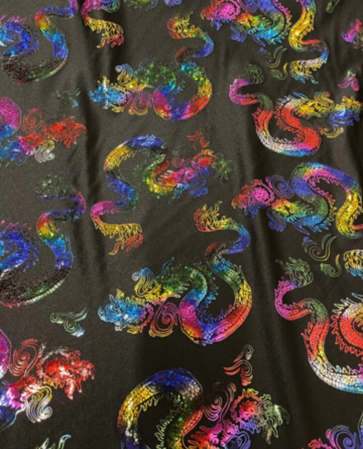 New Dragon design print on metallic nylon spandex Black Iridescent rainbow 4-way stretch spandex 58/60” Sold by the YD. Ships worldwide