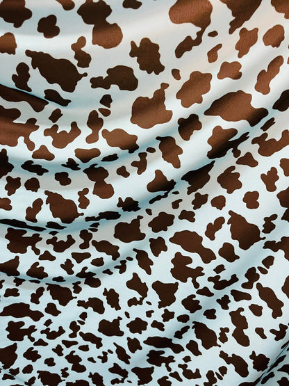 Exotic cow design Turquoise/Black print on great quality of Nylon Spandex 4-way stretch 58/60” Sold by the YD. Ships Worldwide