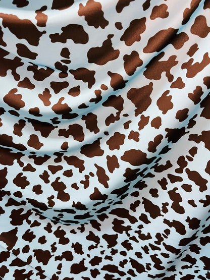 Exotic cow design Turquoise/Black print on great quality of Nylon Spandex 4-way stretch 58/60” Sold by the YD. Ships Worldwide