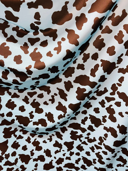 Exotic cow design Turquoise/Black print on great quality of Nylon Spandex 4-way stretch 58/60” Sold by the YD. Ships Worldwide