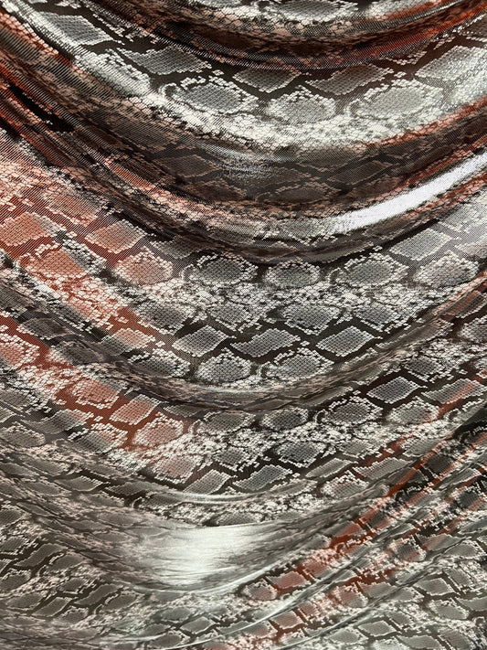 Exotic snake design gray/silver hologram metallic nylon spandex light weight 2-way stretch 58/60” Sold by the YD. Ships worldwide from LA