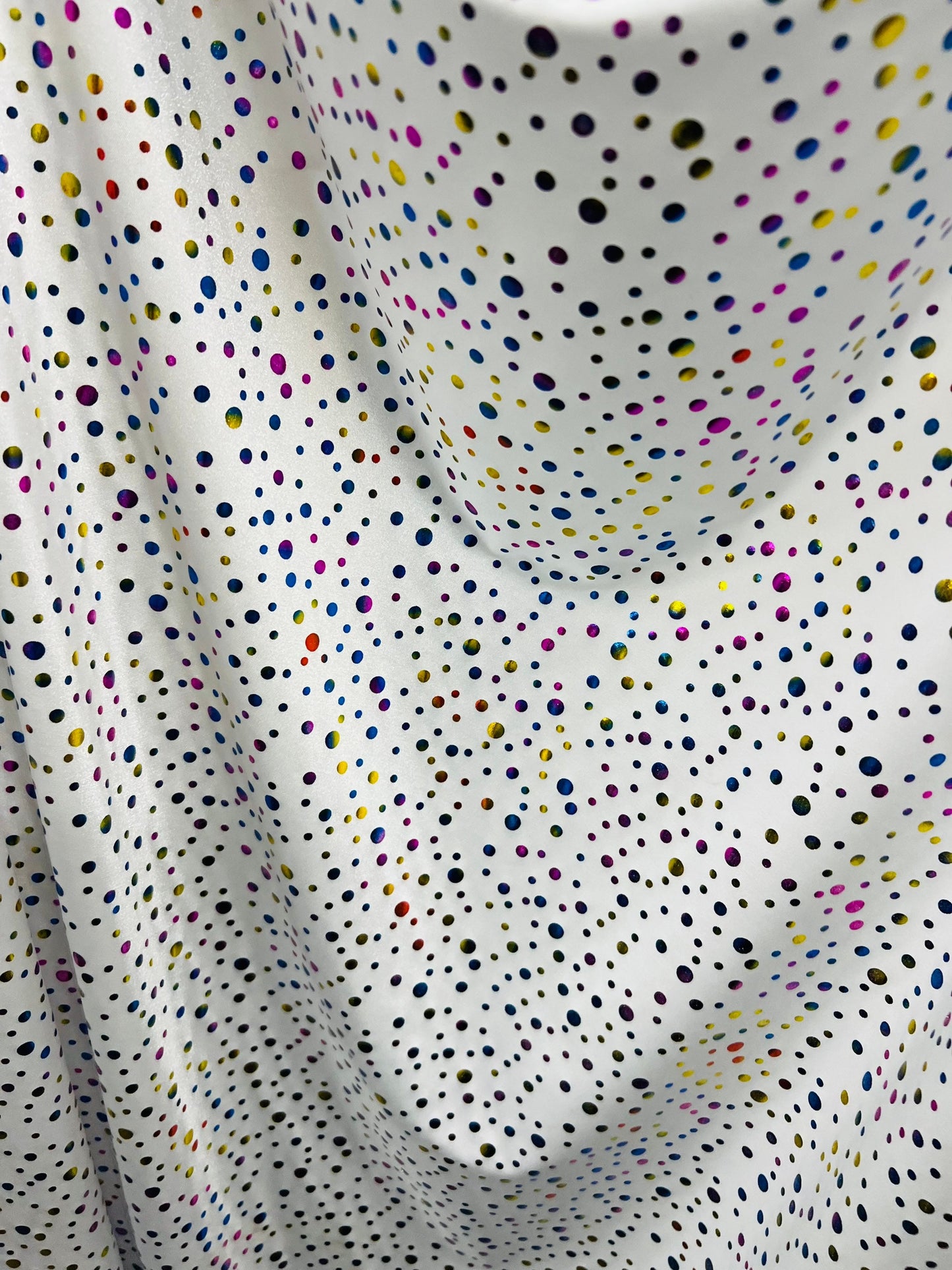 Metallic polka dots design white/multicolor hologram nylon spandex 4-way stretch 58/60” Sold by the YD. Ships Worldwide from Los Angeles CA