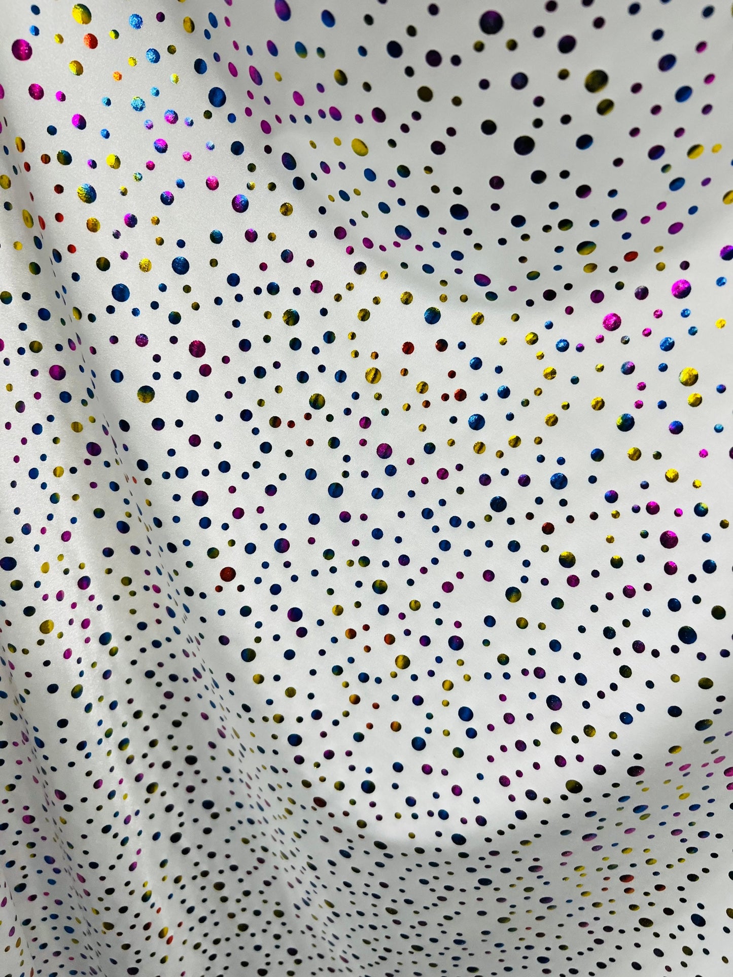 Metallic polka dots design white/multicolor hologram nylon spandex 4-way stretch 58/60” Sold by the YD. Ships Worldwide from Los Angeles CA