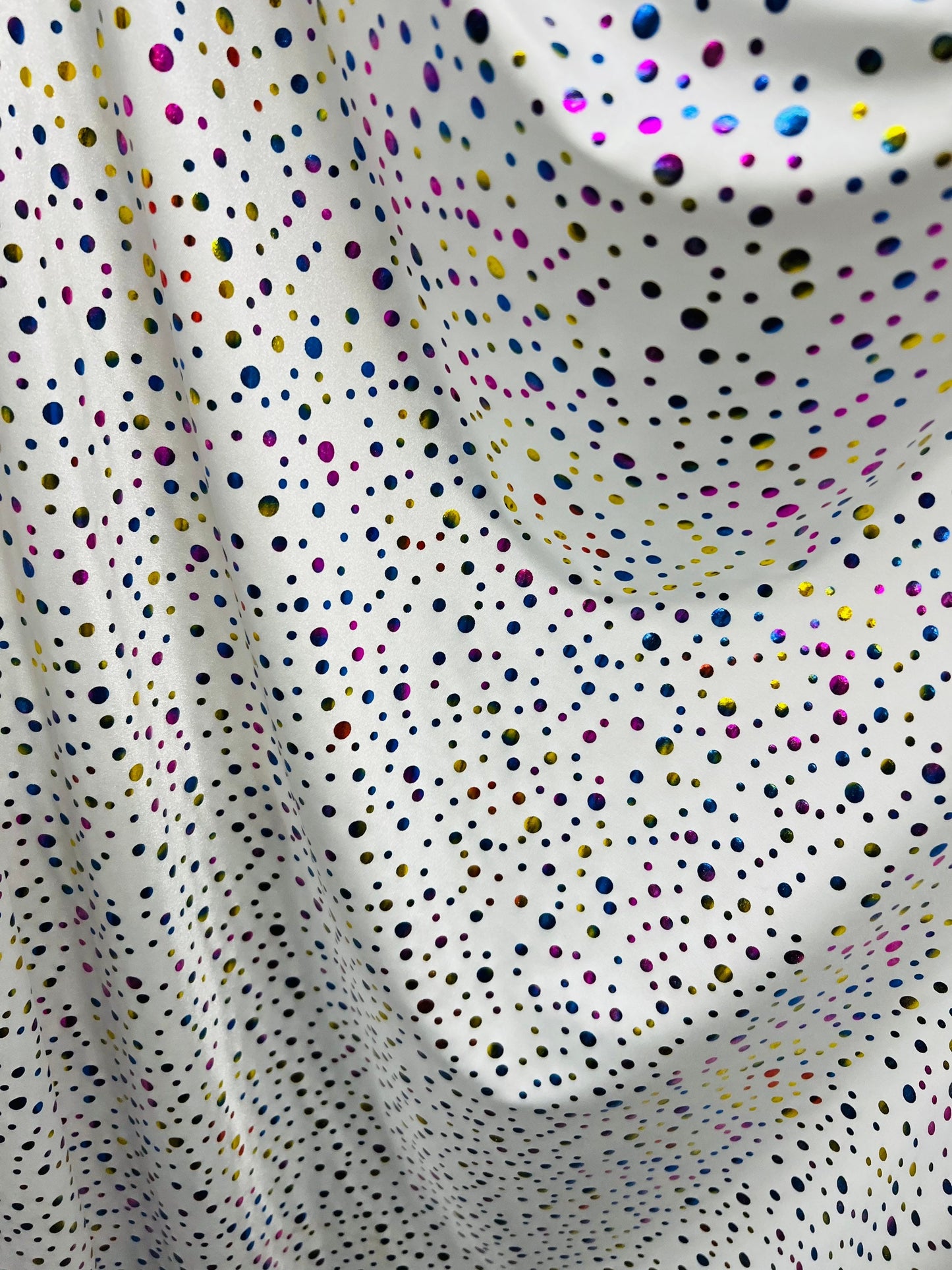 Metallic polka dots design white/multicolor hologram nylon spandex 4-way stretch 58/60” Sold by the YD. Ships Worldwide from Los Angeles CA