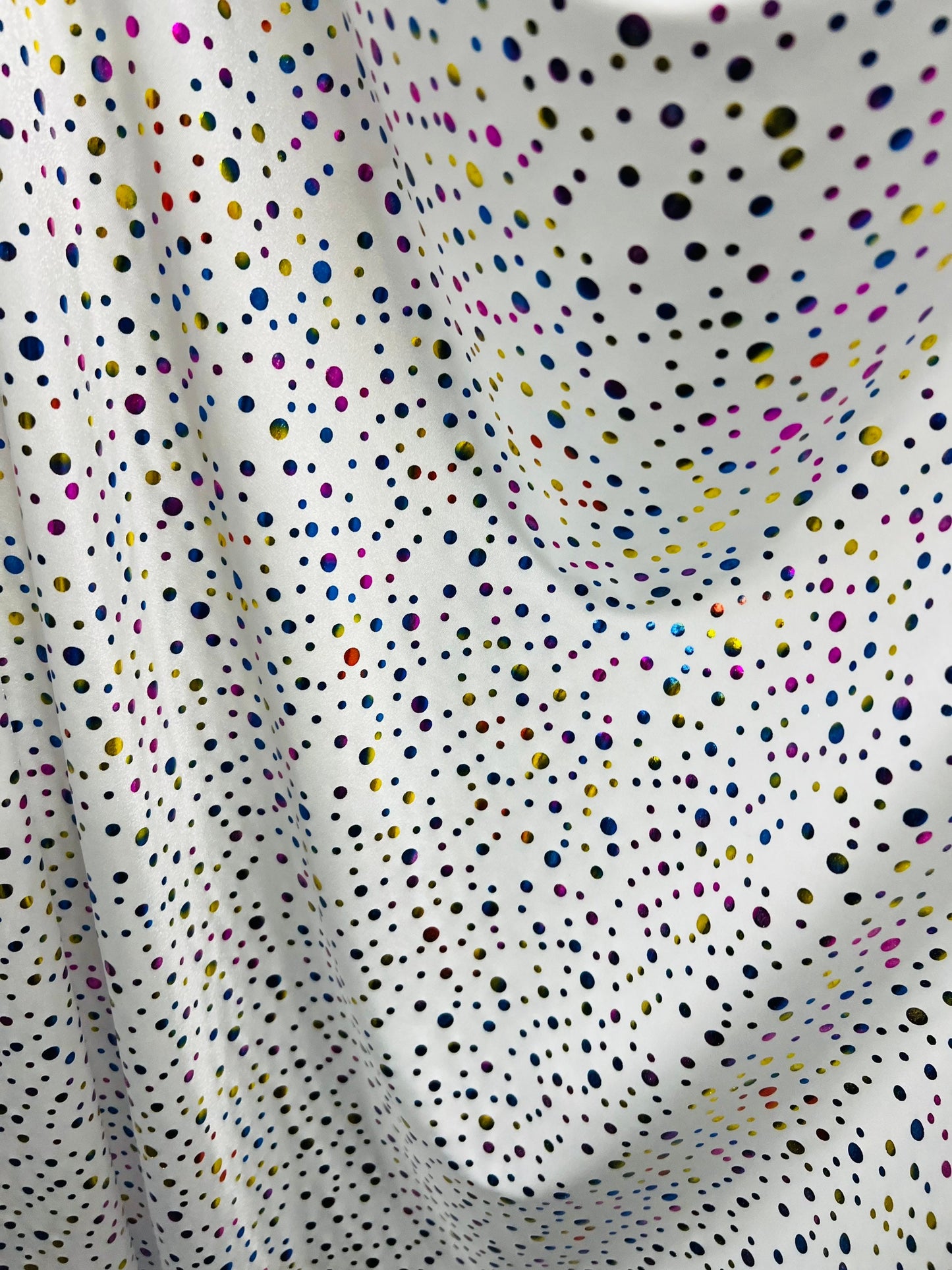 Metallic polka dots design white/multicolor hologram nylon spandex 4-way stretch 58/60” Sold by the YD. Ships Worldwide from Los Angeles CA