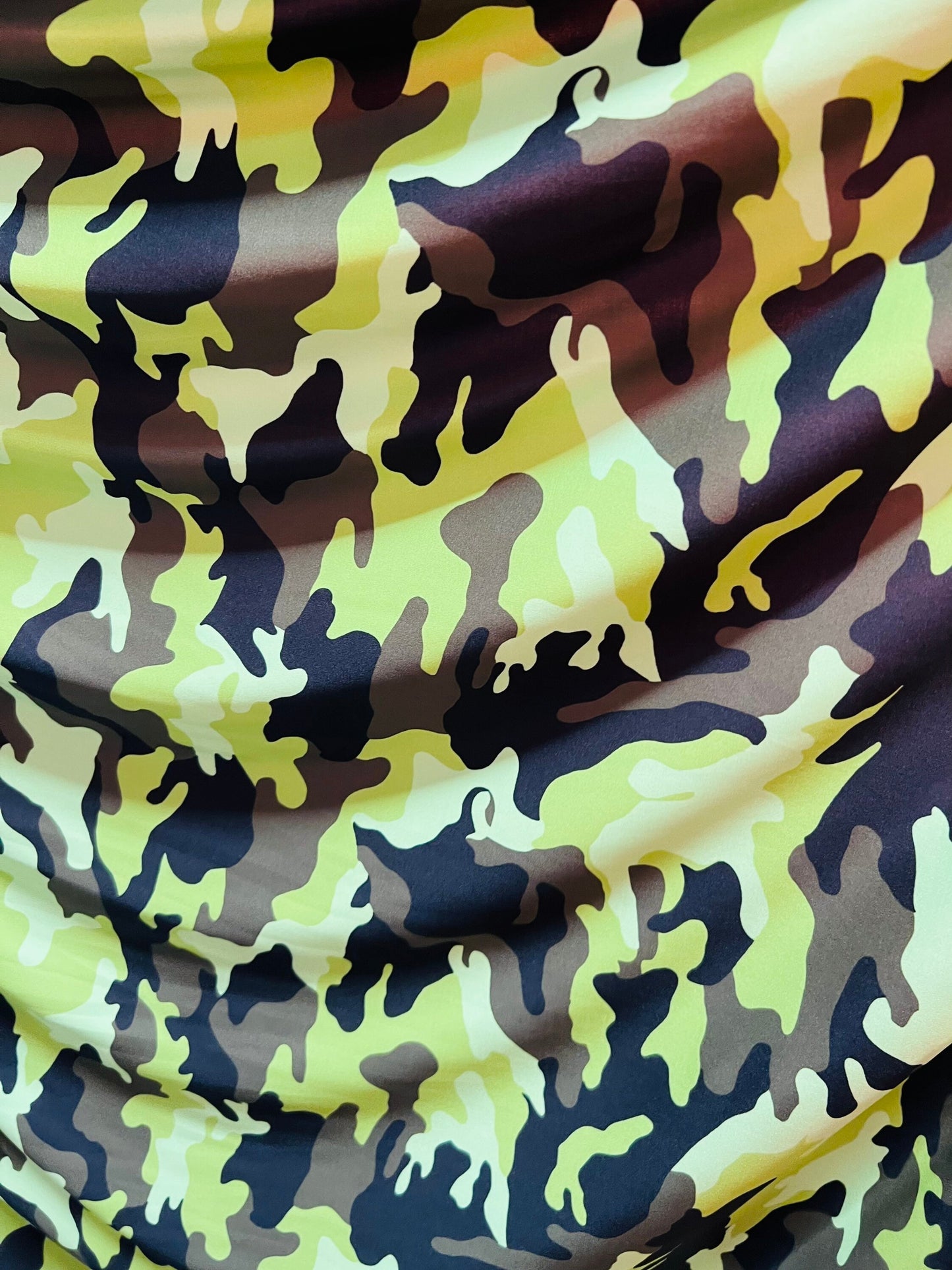 Camouflage design neon green/multi print on great quality of nylon spandex medium weight 4-way stretch 58/60” Sold by the YD.
