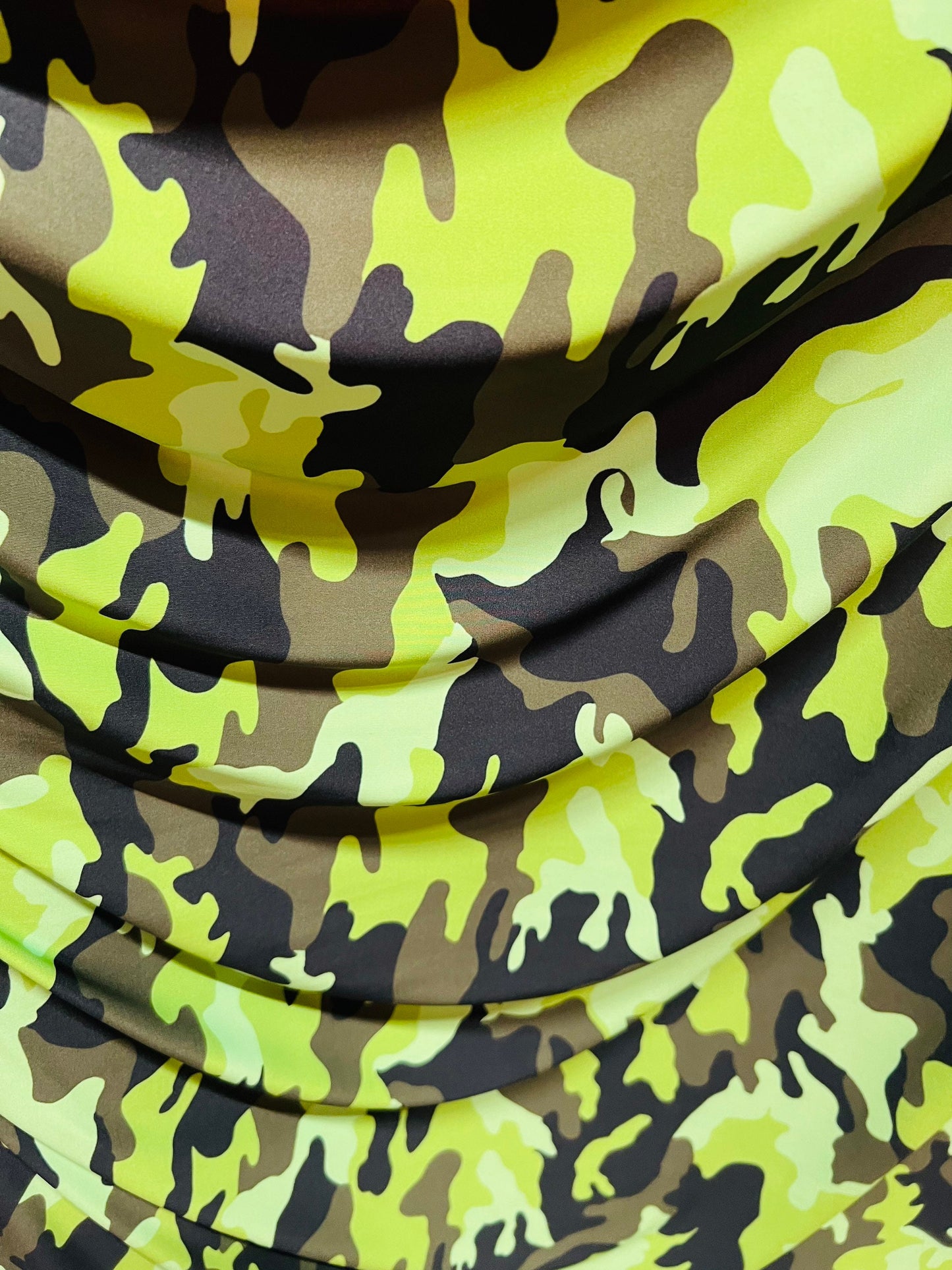 Camouflage design neon green/multi print on great quality of nylon spandex medium weight 4-way stretch 58/60” Sold by the YD.