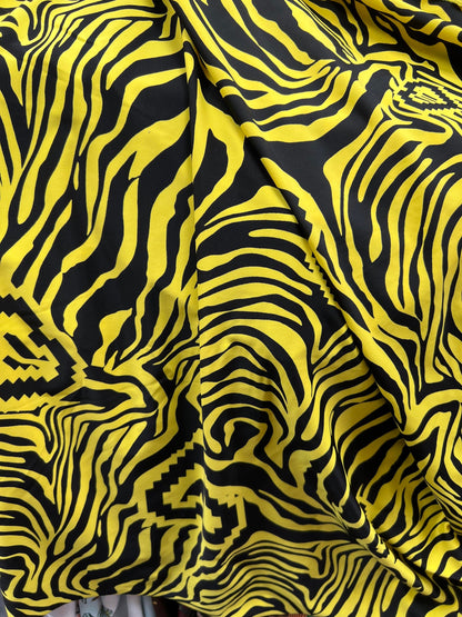 Exotic zebra design black/yellow print on nylon spandex 4way stretch 58/60” Sold by the YD. Ships worldwide from Los Angeles California USA.