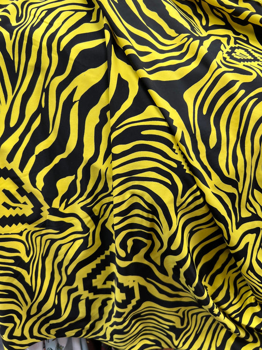 Exotic zebra design black/yellow print on nylon spandex 4way stretch 58/60” Sold by the YD. Ships worldwide from Los Angeles California USA.