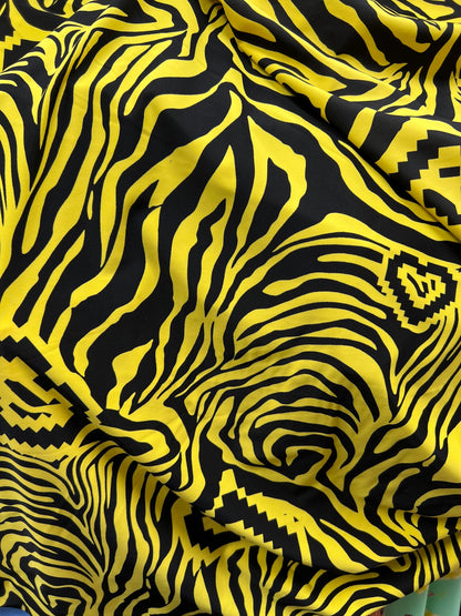 Exotic zebra design black/yellow print on nylon spandex 4way stretch 58/60” Sold by the YD. Ships worldwide from Los Angeles California USA.