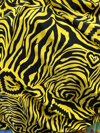 Exotic zebra design black/yellow print on nylon spandex 4way stretch 58/60” Sold by the YD. Ships worldwide from Los Angeles California USA.