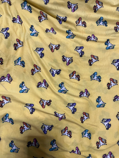 Little Pony design print on light weight poly spandex 4-way stretch yellow/multicolor 58/60” Sold by the YD.