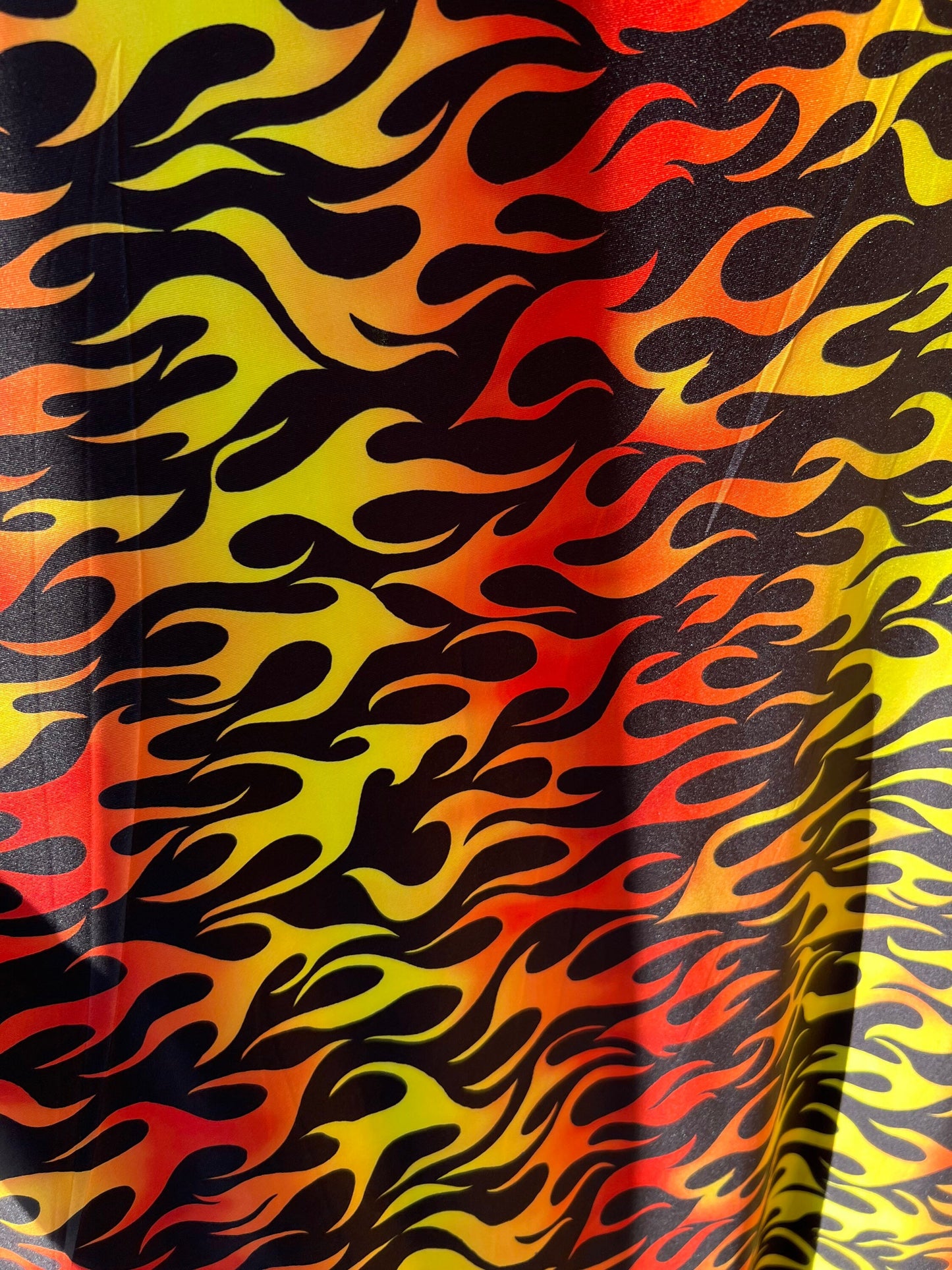 New Flame design Black/Fire color print on light weight poly spandex 2-way stretch 58/60” Sold by the Yd.